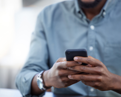 Businessman, phone and typing at desk in closeup