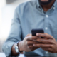 Businessman, phone and typing at desk in closeup