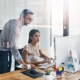 Tech professional helping office worker with computer